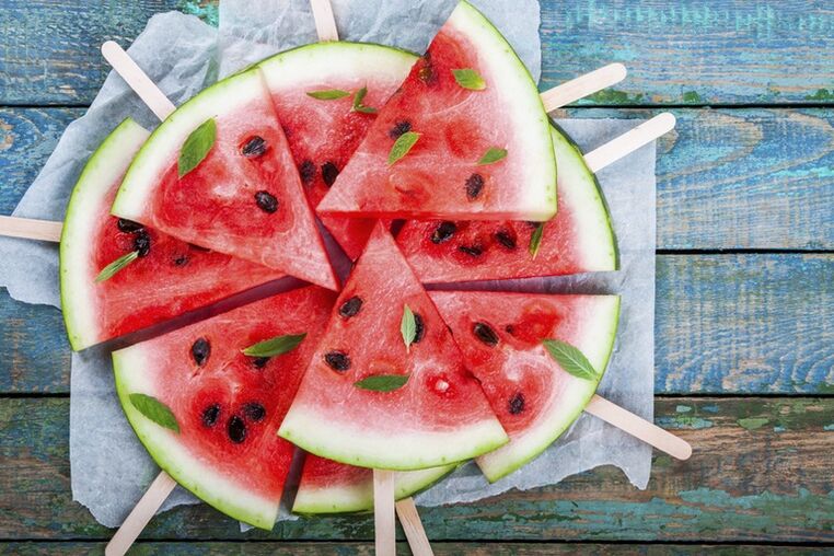 Watermelon slices on chopsticks for a snack on a watermelon diet